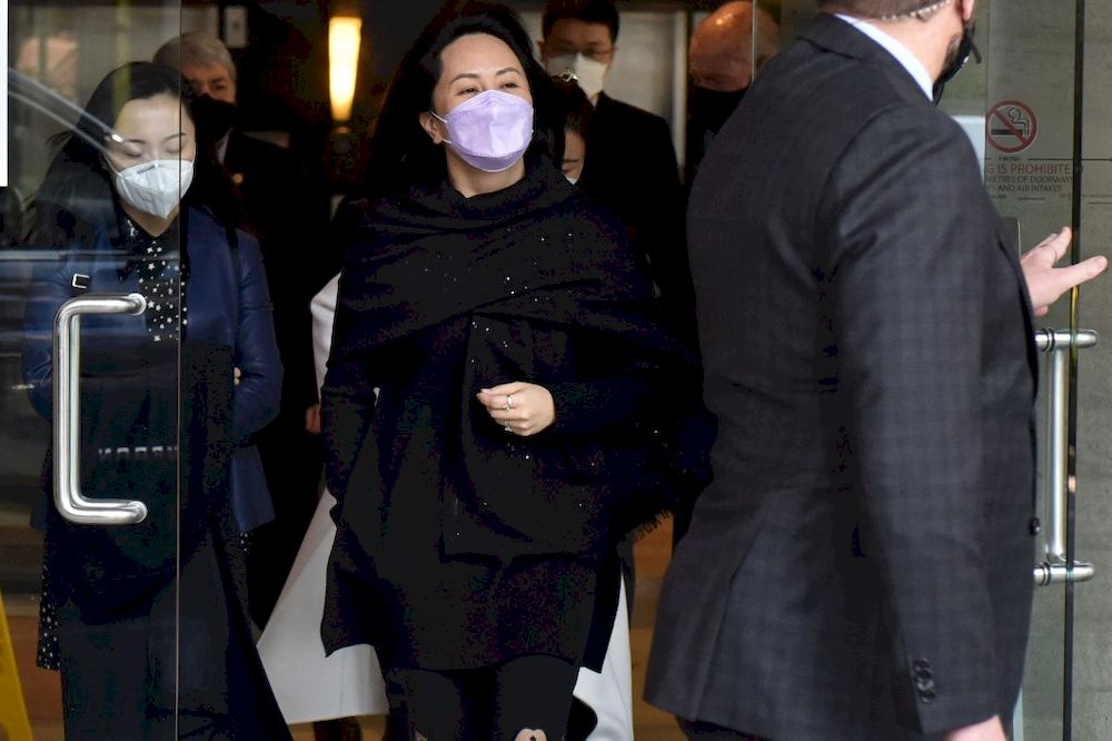Huawei Chief Financial Officer, Meng Wanzhou (centre) leaves the British Columbia Supreme Court with her security detail in Vancouver, British Colombia, March 22, 2021. u00e2u20acu201d AFP pic