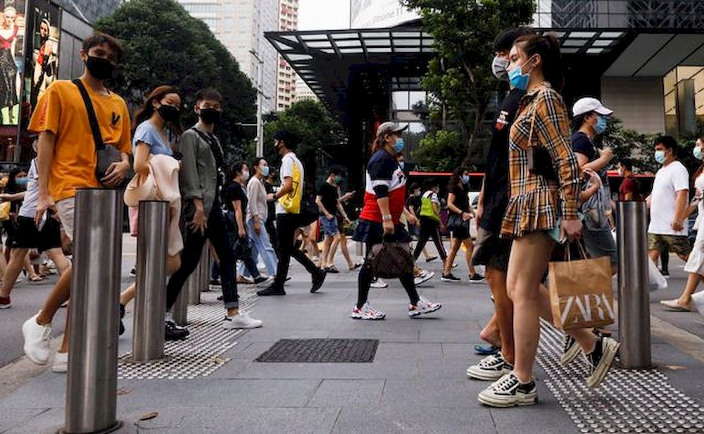 File picture shows people crossing a street at the shopping district of Orchard Road in Singapore, June 19, 2020. u00e2u20acu201d Reuters pic