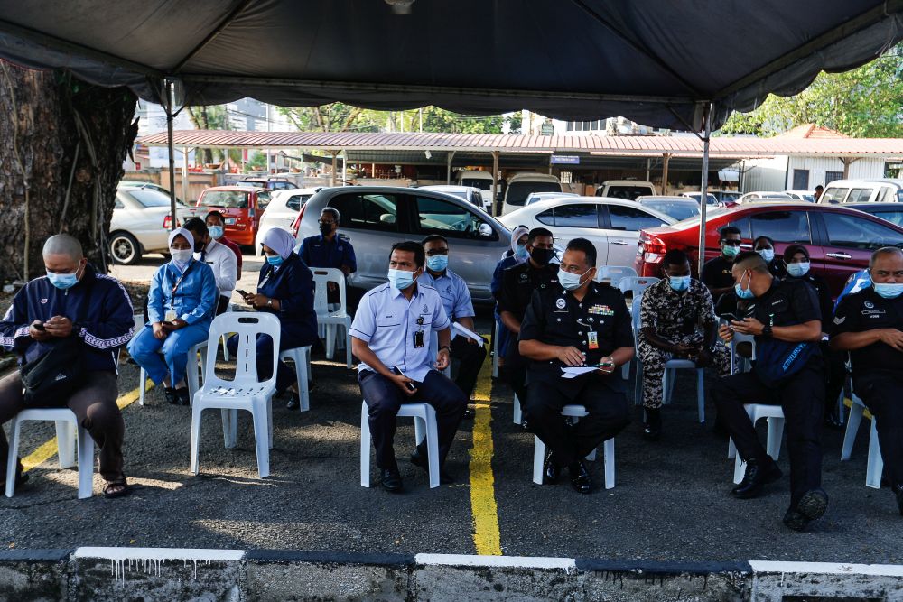 Frontliners comprising personnel from the Prisons Department, Fire Department, PDRM and hospitals wait to receive their Covid-19 jabs at the Jalan Perak Health Clinic in Jelutong March 4, 2021. u00e2u20acu201d Picture by Sayuti Zainudin