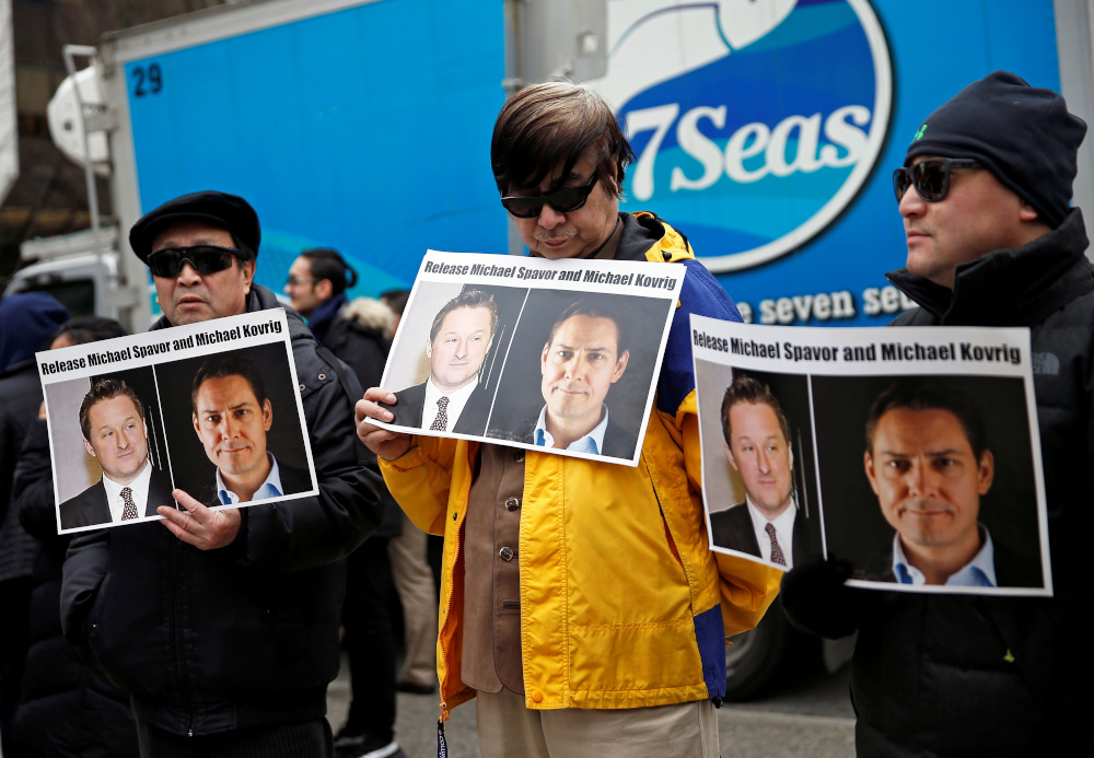 People hold placards calling for China to release Canadian detainees Michael Spavor and Michael Kovrig outside a court hearing for Huawei CFO Meng Wanzhou at the BC Supreme Court in Vancouver March 6, 2019. u00e2u20acu201d Reuters pic