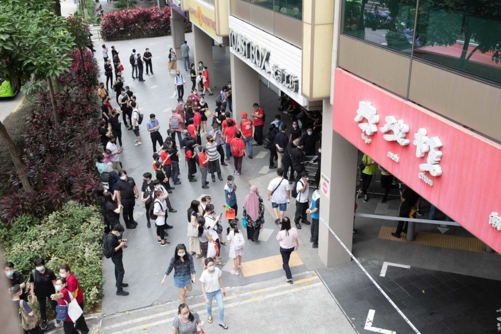 Crowds are seen outside Chinatown Point about 12pm on Friday, March 12. Singapore Police Force (SPF) cordoned off the mall with barricade tape. u00e2u20acu201d TODAY picnn