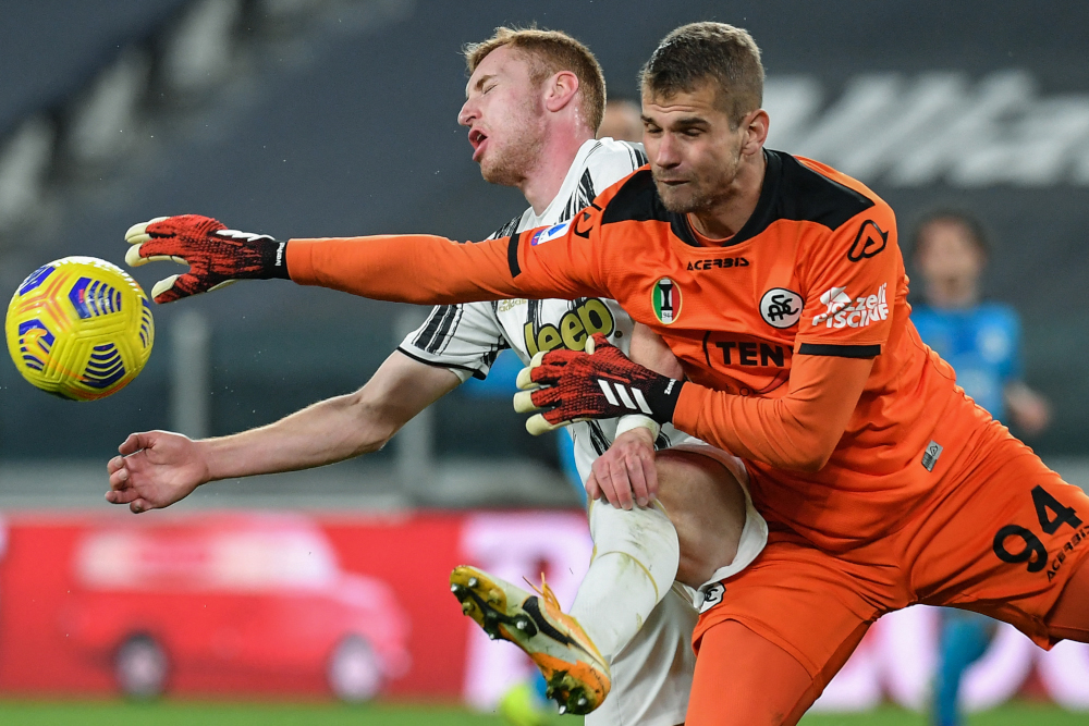 Spezia goalkeeper Ivan Provedel (right) deflects the ball from Juventus forward Dejan Kulusevski during the Italian Serie A football match Juventus vs Spezia March 2, 2021 at the Juventus stadium in Turin. u00e2u20acu201d AFP  pic 