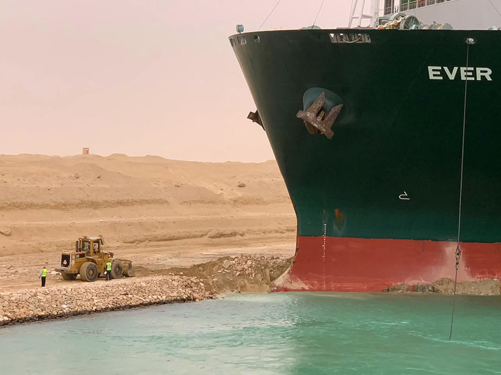 A handout picture released by the Suez Canal Authority March 24, 2021 shows a part of the Taiwan-owned MV Ever Given (Evergreen) lodged sideways and impeding all traffic across the waterway of Egyptu00e2u20acu2122s Suez Canal. u00e2u20acu201d Suez Canal handout pic via AFP 