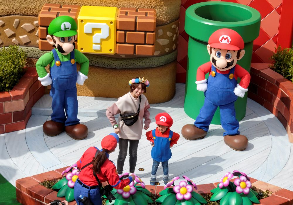 Mario and Luigi characters greet visitors in front of Yoshi's Adventure attraction inside Super Nintendo World at the Universal Studios Japan theme park in Osaka March 17, 2021.u00e2u20acu201d Reuters pic