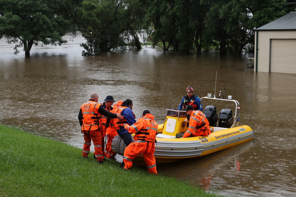State Emergency Service personnel load a dentist onto a boat to transport him from the suburb of Windsor to North Richmond across floodwaters, in Sydney, Australia, March 22, 2021. u00e2u20acu201d Reuters picnn
