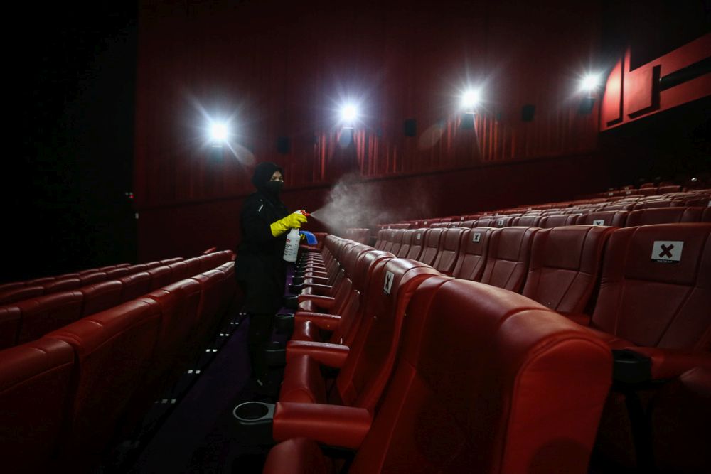 A worker disinfects cinema seats at TGV Bukit Tinggi, Klang March 4, 2021. u00e2u20acu201d Picture by Yusof Mat Isa