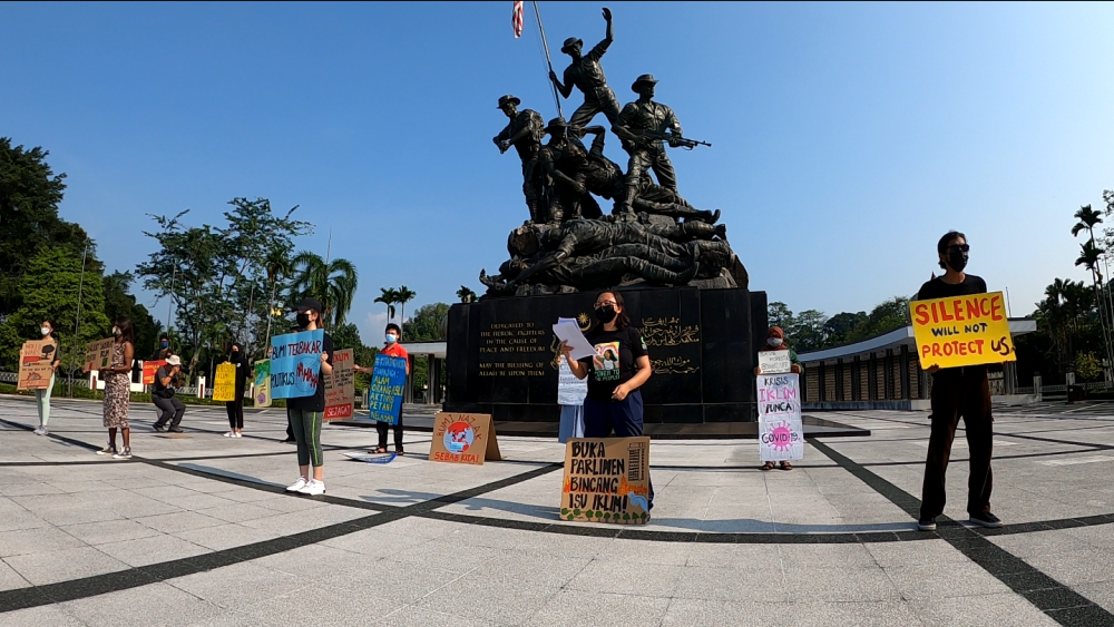 Activists are seen holding up placards to protest the global climate crisis at Tugu Negara, Kuala Lumpur March 19, 2021. u00e2u20acu2022 Picture courtesy of Klima Action Malaysia