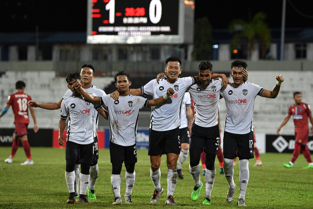 Terengganu FC II player Mohamad Ramzi Sufian (right) celebrates with his teammates after scoring the first goal against PDRM FC, April 3, 2021. u00e2u20acu201d Bernama pic