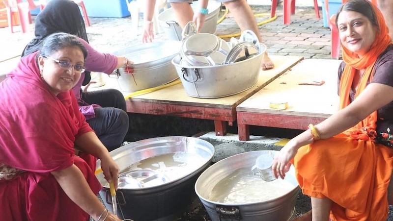 Members of the gurdwara washing kitchen utensils to be used for the Vaisakhi lunch later today. u00e2u20acu201d Picture courtesy of Gurpreet Singh
