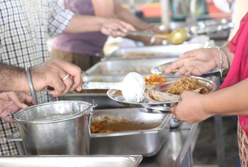 Lunch prepared and served by devotees from PJ gurdwara on Vaisakhi eve. — Picture courtesy of Gurpreet Singh
