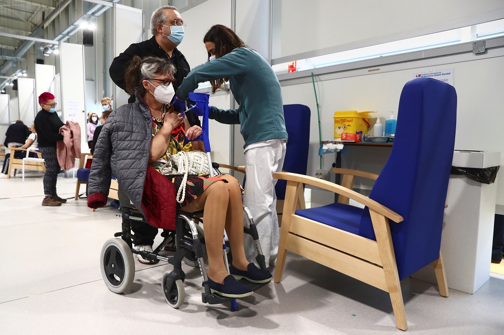 A woman in a wheelchair receives her first dose of the AstraZeneca COVID-19 vaccine at Enfermera Isabel Zendal hospital in Madrid April 6, 2021. u00e2u20acu201d Reuters pic