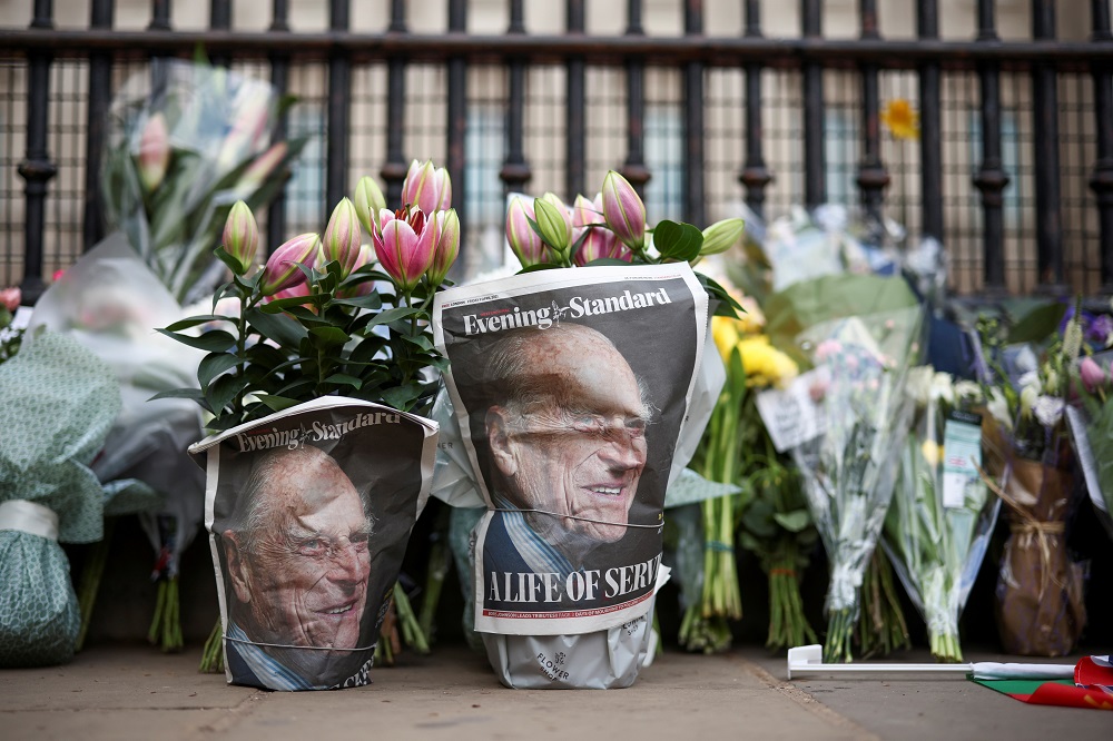 A picture of Britainu00e2u20acu2122s Prince Philip, husband of Queen Elizabeth, is seen in the newspapers wrapped around flowers, after he died at the age of 99, in London April 9, 2021. u00e2u20acu201d Reuters pic