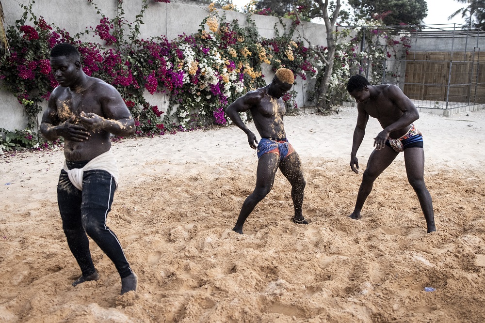Senegalese wrestlers cover themselves in sand as they prepare to start their training programme in Petit Mbao. u00e2u20acu201d AFP pic