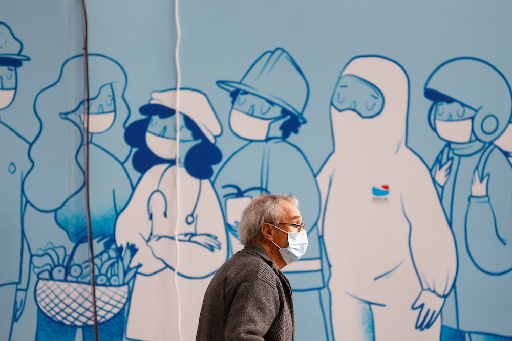A man wearing a protective mask walks at a Covid-19 vaccination centre in Seixal, Portugal, March 22, 2021. u00e2u20acu201d Reuters pic