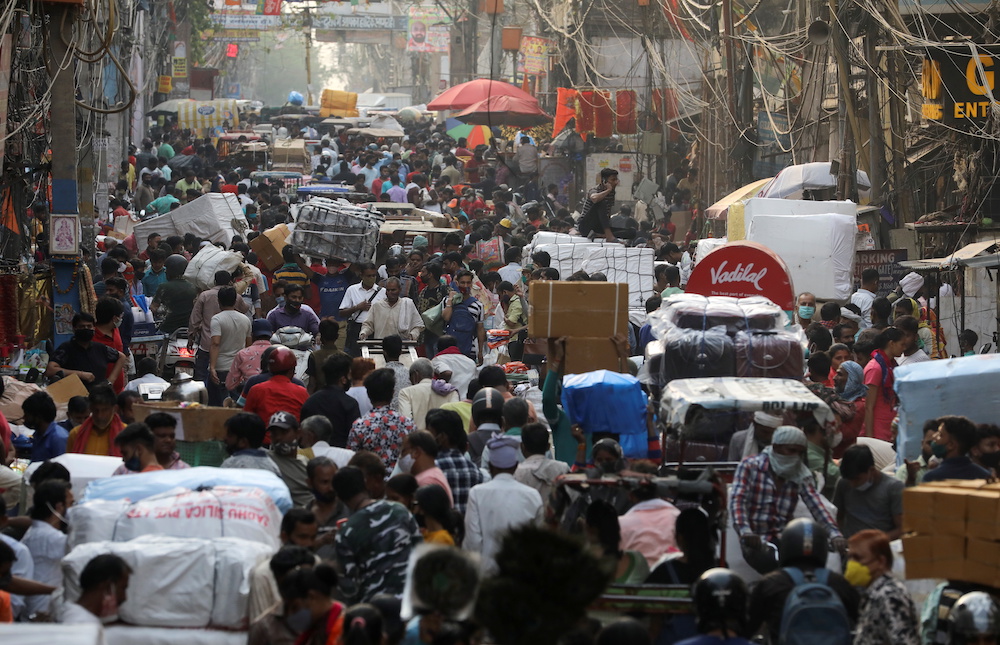 People walk at a crowded market amidst the spread of the coronavirus disease (Covid-19), in the old quarters of Delhi, India, April 6, 2021. u00e2u20acu201d Reuters picnn