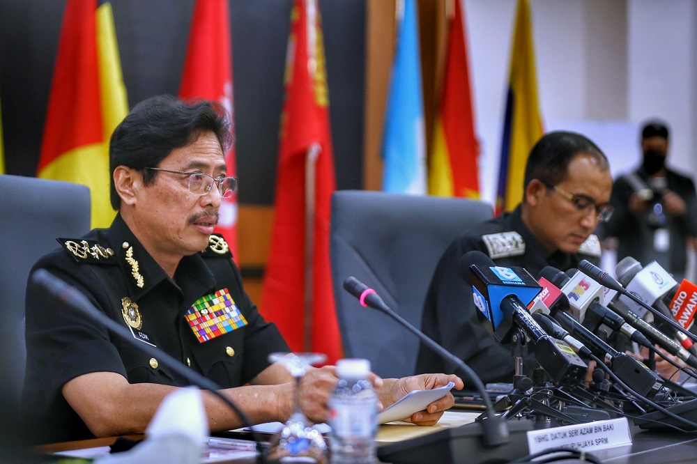 Malaysian Anti-Corruption Commission chief commissioner Datuk Seri Azam Baki (left) and Immigration Department director general Datuk Indera Khairul Dzaimee Daud attend a press conference in Kuala Lumpur April 7, 2021. u00e2u20acu201d Picture by Ahmad Zamzahuri