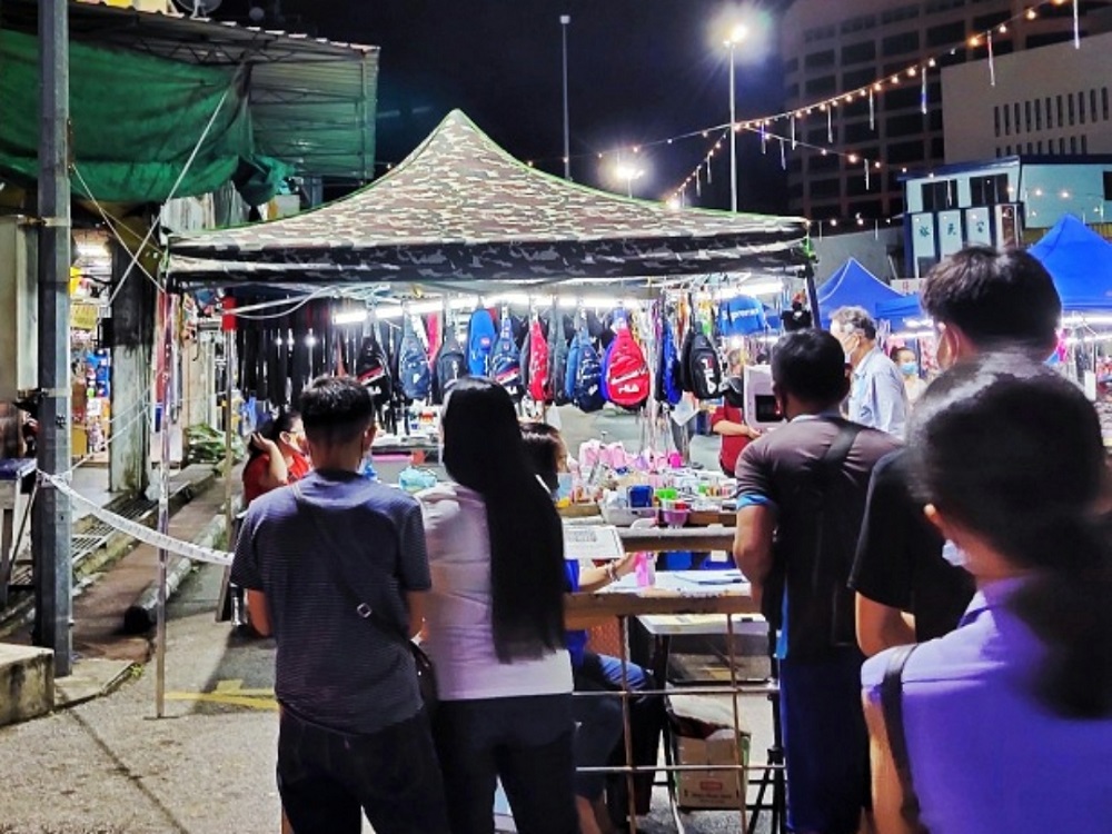 Visitors checking in via MySejahtera at the Butterfly Garden night market in Sibu when it was opened previously. u00e2u20acu201d Borneo Post Online pic