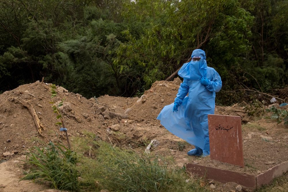 A relative of a man, who died from the coronavirus disease (Covid-9), waits for the burial at a graveyard in New Delhi, India, April 16, 2021. u00e2u20acu201d Reuters pic