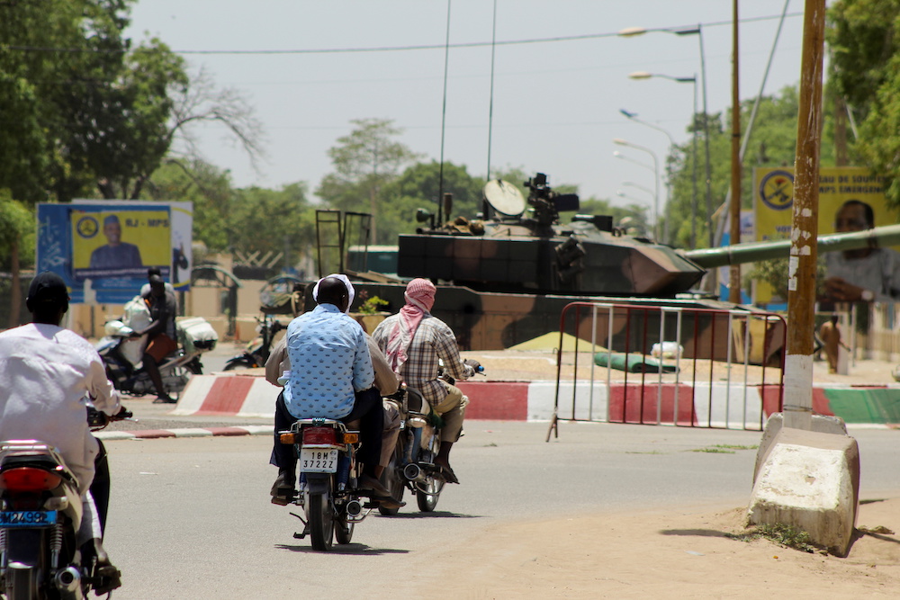 People drive past a Chad army tank near the presidential palace, after Chad's President Idriss Deby, was killed on the frontline in a battle against rebels in the north, in N'djamena, Chad April 20, 2021. u00e2u20acu201d Reuters picn n