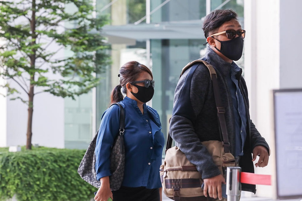 Khairul Annuar Zakaria (right) and Noorain Jubli are seen arriving State Courts on April 21, 2021. u00e2u20acu201d TODAY pic