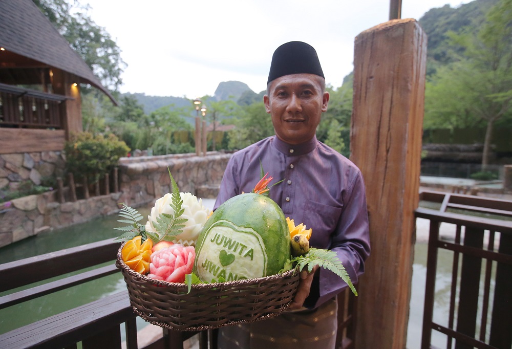During the ceremony, the 'newlyweds' were fed a basket of fruits to celebrate their union. — Picture by Farhan Najib 
