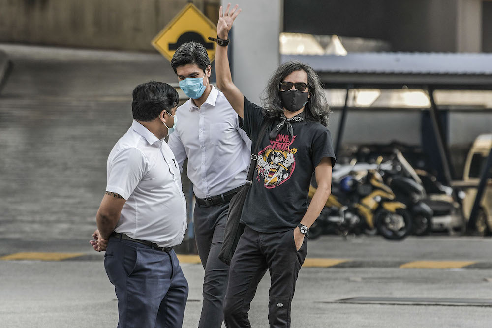 Graphic designer Mohd Fahmi Reza Mohd Zarin (centre) is shown here outside the Dang Wangi district police station after his release from his overnight arrest and one-day remand April 24, 2021. u00e2u20acu2022 Picture by Hari Anggarann