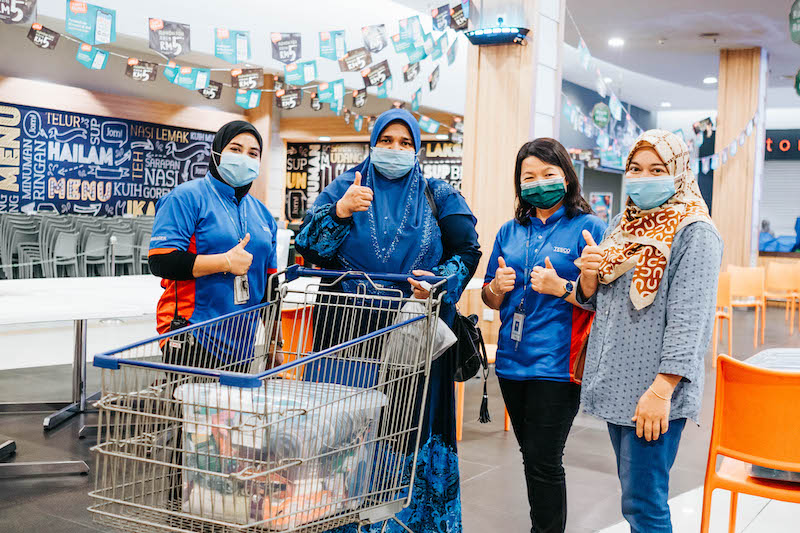 Lotusu00e2u20acu2122s Kota Baru colleagues pose with a Kiriman Ikhlas Raya and Tabung Kiriman Ikhlas beneficiary on April 20. u00e2u20acu201d Picture courtesy of Lotus Stores Malaysia