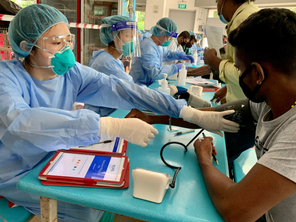A member of the team behind the study taking blood pressure reading from a participant. u00e2u20acu201d NUHS pic via TODAY