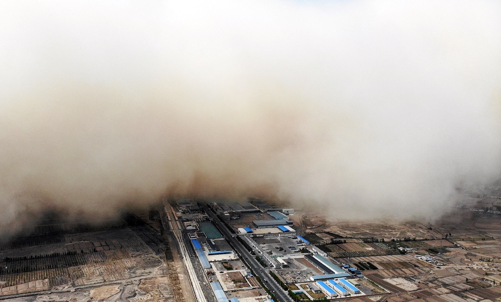 This aerial photo taken on April 25, 2021 shows a sandstorm engulfing a village in Linze county, in the city of Zhangye in China's northwestern Gansu province. u00e2u20acu201d AFP pic