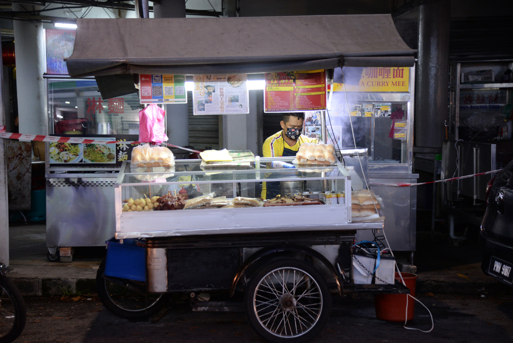 Tan Boon selling from his motorcycle hawker stall. u00e2u20acu201d  Picture by Steven Ooi KE