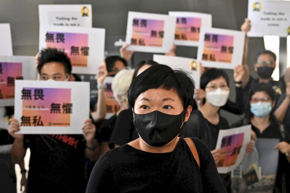Radio Television Hong Kong (RTHK) producer Bao Choy Yuk-ling (centre) arrives at the West Kowloon Courts building in Hong Kong on April 22, 2021. u00e2u20acu201d AFP pic
