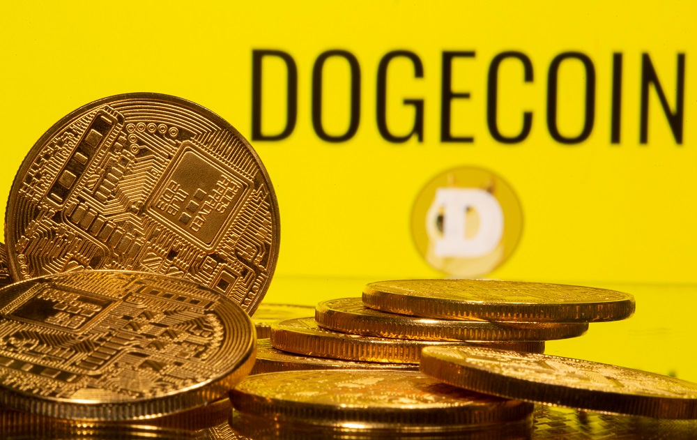 Cryptocurrency representations are seen in front of the Dogecoin logo in this illustration picture taken April 20, 2021. u00e2u20acu2022 Reuters pic