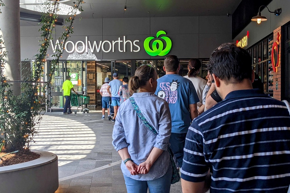 Shoppers line up outside a Woolworths store as greater Brisbane has been ordered into a snap three-day lockdown after four more Covid-19 cases emerged in the community, in Brisbane March 29, 2021. u00e2u20acu2022 Handout via Reuters