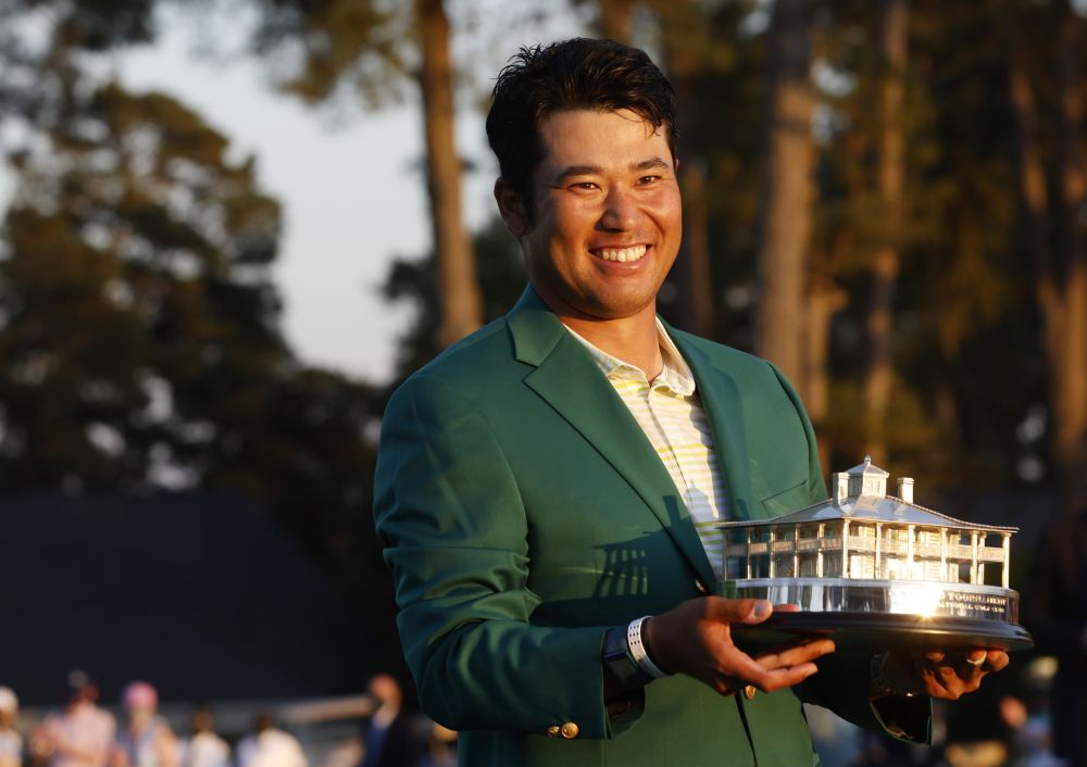 Japan's Hideki Matsuyama celebrates with the green jacket and the trophy after winning The Masters at the Augusta National Golf Club April 11, 2021. u00e2u20acu201d Reuters pic