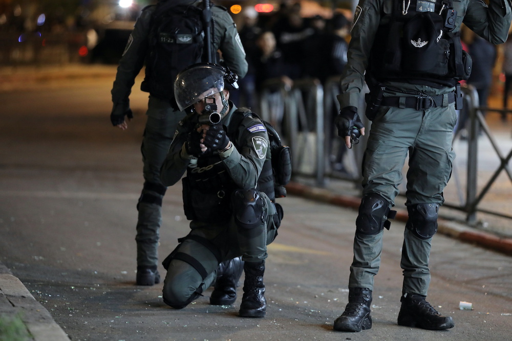 An Israeli police officer aims during clashes with Palestinian protesters, as the Muslim holy fasting month of Ramadan continues, in Jerusalem, April 23, 2021. u00e2u20acu201d Reuters picnn