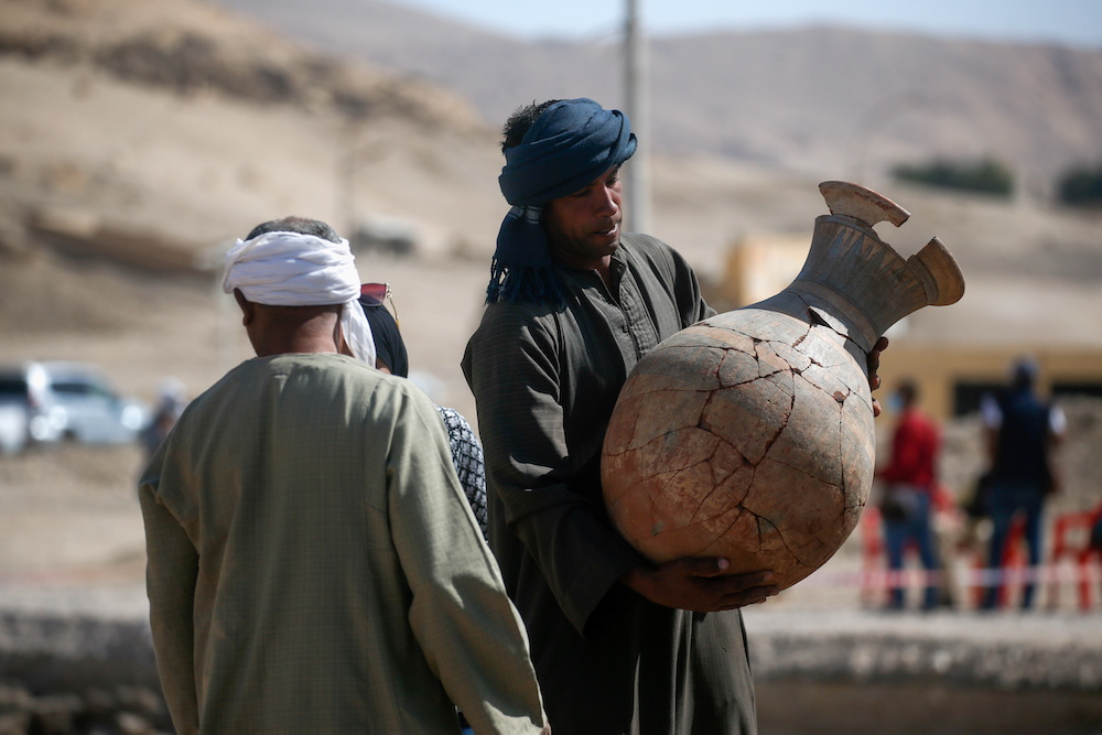 A person holds an unearthed pot at the site of the u00e2u20acu02dcLost Golden Cityu00e2u20acu2122, which was recently discovered by archaeologists, in the West Bank of Luxor, Upper Egypt, April 10, 2021. u00e2u20acu201d Reuters pic
