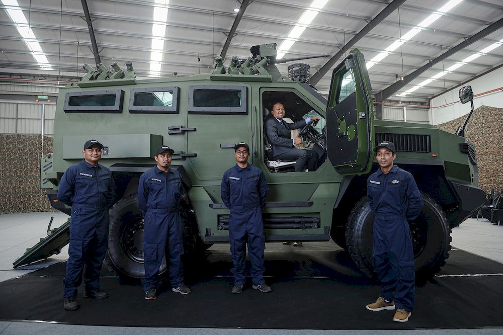 MILDEF Chief Executive Officer Datuk Seri Mohd Nizam Kasa with several crew members posing with the MILDEF HMAV4x4 armored car at MILDEF, Feb 11, 2021. u00e2u20acu201d Bernama pic