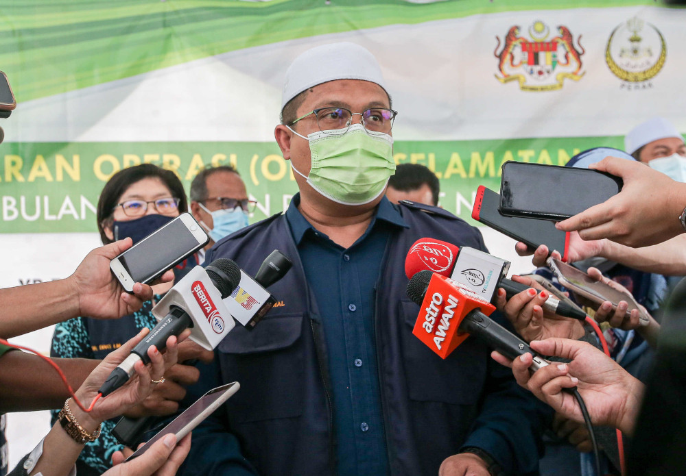 Perak Health, Science, Environment and Green Technology Committee chairman Mohd Akmal Kamarudin speaking to the press after launching a food safety operation at the Dataran Orkid Ramadan bazaar in Batu Gajah, April 20, 2021. u00e2u20acu201d Picture by Farhan Najibn