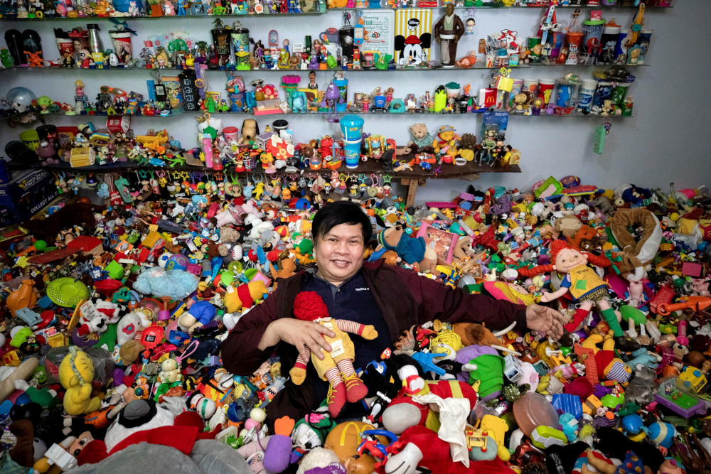 Percival Lugue, who has the Guinness world record for the largest fast-food toy collection, poses with his toy collection in his home in Apalit, Pampanga province, Philippines, April 20, 2021. u00e2u20acu201d Reuters picnn