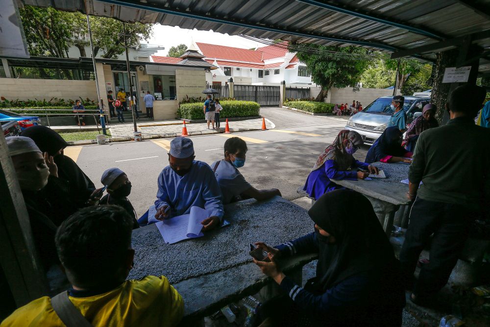 Thai nationals register for their departures from Penang at the Royal Thai Consulate-General, Jalan Tunku Abdul Rahman April 20, 2021. — Picture by Sayuti Zainudin