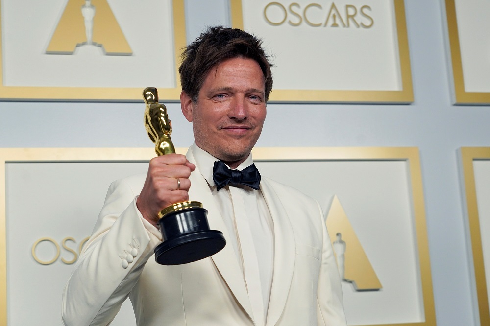 Thomas Vinterberg, from Denmark, poses in the press room with the award for Best International Feature Film for u00e2u20acu02dcAnother Roundu00e2u20acu2122 at the Oscars in Los Angeles, California April 25, 2021. u00e2u20acu2022 Pool via Reuters
