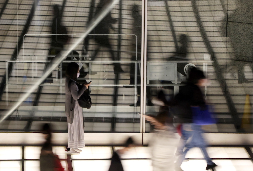 Passersby wearing protective face mask walk past a concourse amid the coronavirus disease outbreak in Tokyo, Japan April 16, 2021. Picture taken April 16, 2021. u00e2u20acu201d Reuters picnn