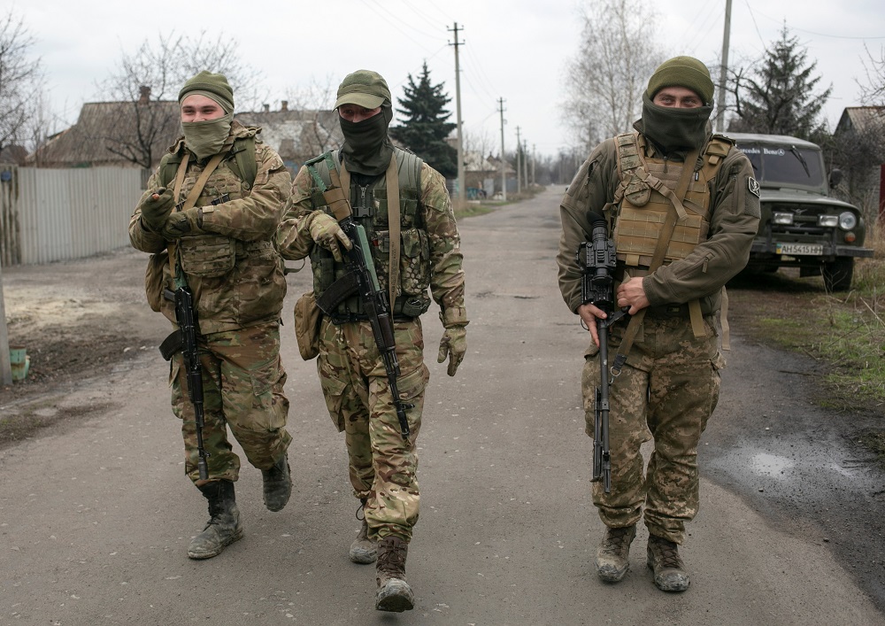 Service members of the Ukrainian armed forces walk along a street in the town of Marinka in Donetsk Region, Ukraine April 14, 2021. u00e2u20acu2022 Reuters pic