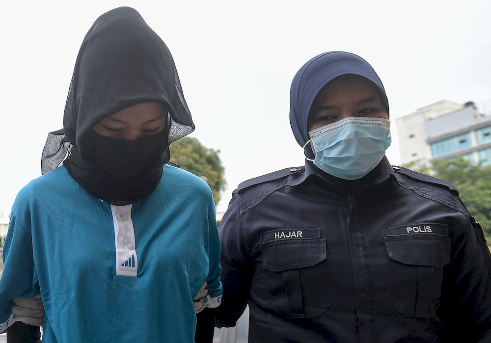 Umiezatul Asyikin Nasrun being brought before the Bandar Baru Bangi Magistrate's Court, March 12, 2021. u00e2u20acu201d Bernama pic