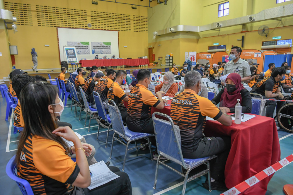 Athletes wait to get their Pfizer-BioNTech vaccinations at the DBKL sports hall in Kuala Lumpur during the Youth and Sports Ministryu00e2u20acu2122s Covid-19 Immunisation Programme, April 13, 2021. u00e2u20acu201d Bernama pic