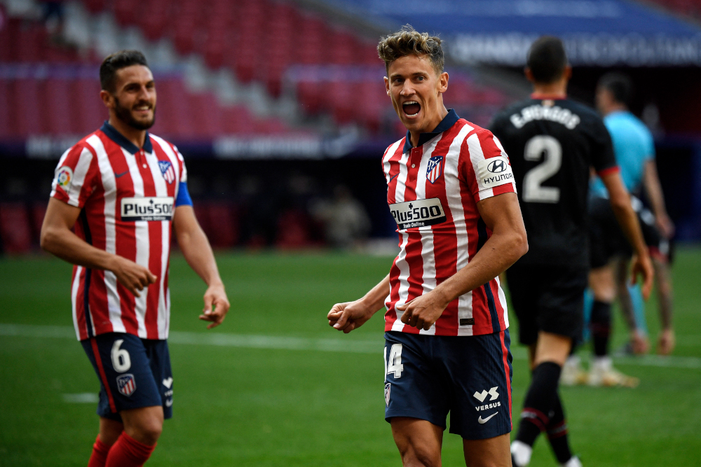 Atletico Madrid midfielder Marcos Llorente celebrates with midfielder Koke after scoring a goal during the Spanish League football match between Club Atletico de Madrid and SD Eibar at the Wanda Metropolitano stadium in Madrid April 18, 2021. u00e2u20acu201d AFP pic 