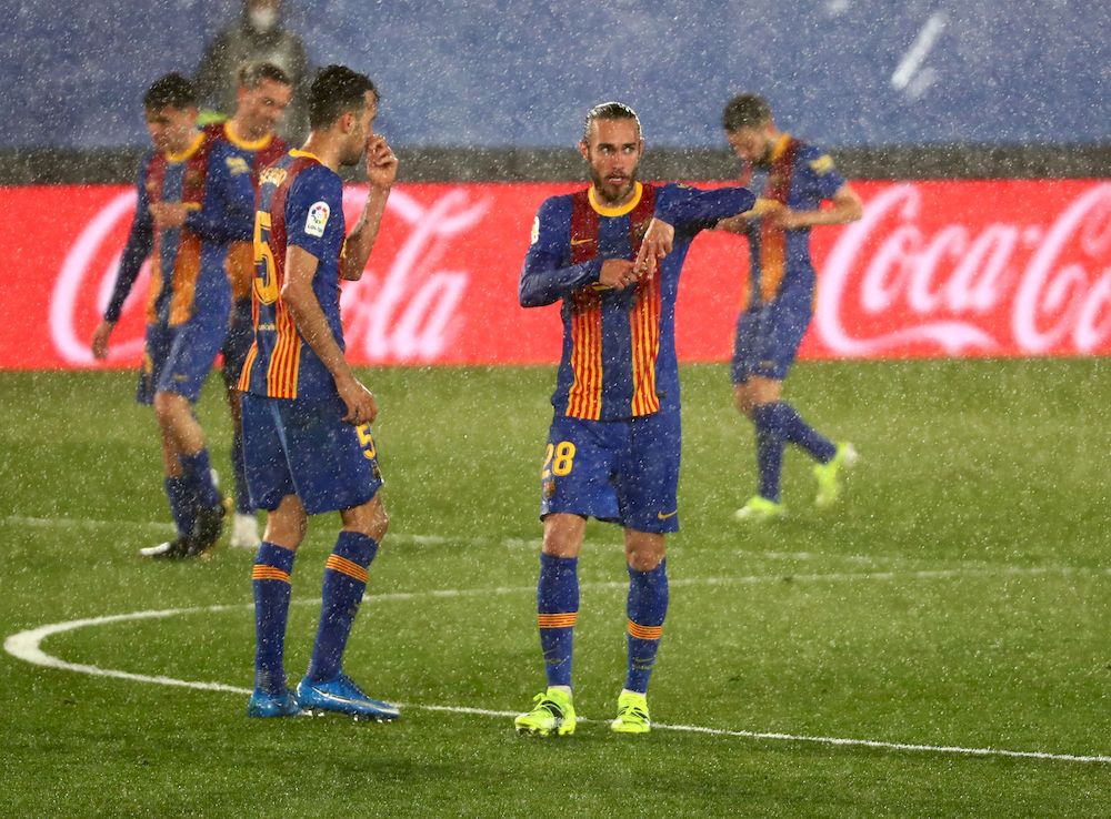Barcelonau00e2u20acu2122s Oscar Mingueza celebrates scoring their first goal with Sergio Busquets during their La Liga match against Real Madrid at Estadio Alfredo Di Stefano, Madrid, Spain, April 10, 2021. u00e2u20acu201d Reuters pic