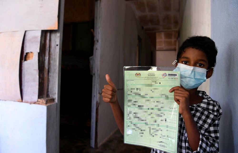 R. Solaman Vijay poses with his birth certificate at his home in Batu Maung, Penang April 3, 2021. u00e2u20acu201d Bernama pic