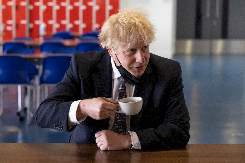 Britainu00e2u20acu2122s Prime Minister Boris Johnson, holds a cup of coffee as he speaks with pupils after taking part in a science lesson at King Solomon Academy in London, on April 29, 2021. u00e2u20acu201d AFP pic