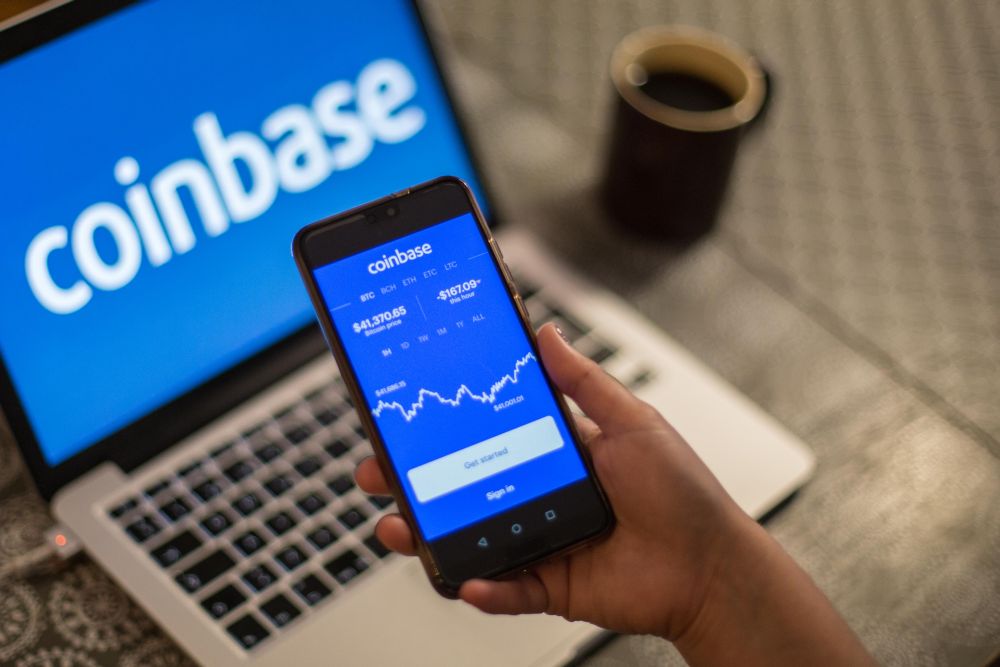 A Coinbase App and logo is seen displayed on a smartphone and a laptop in the background January 1, 2021. u00e2u20acu201d Reuters pic